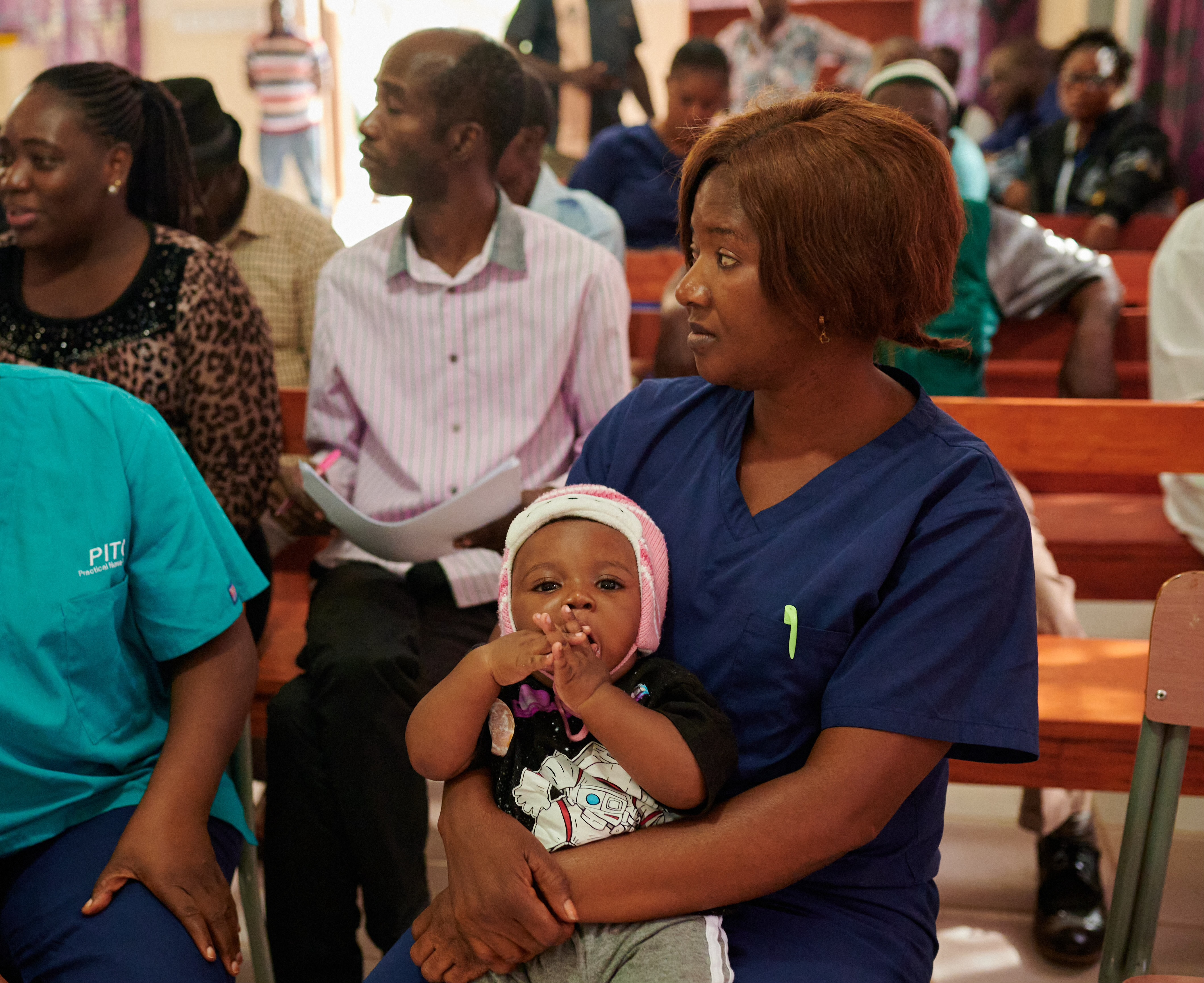 Healthcare worker caring for a patient at a Devoted Skies partner clinic in Freetown